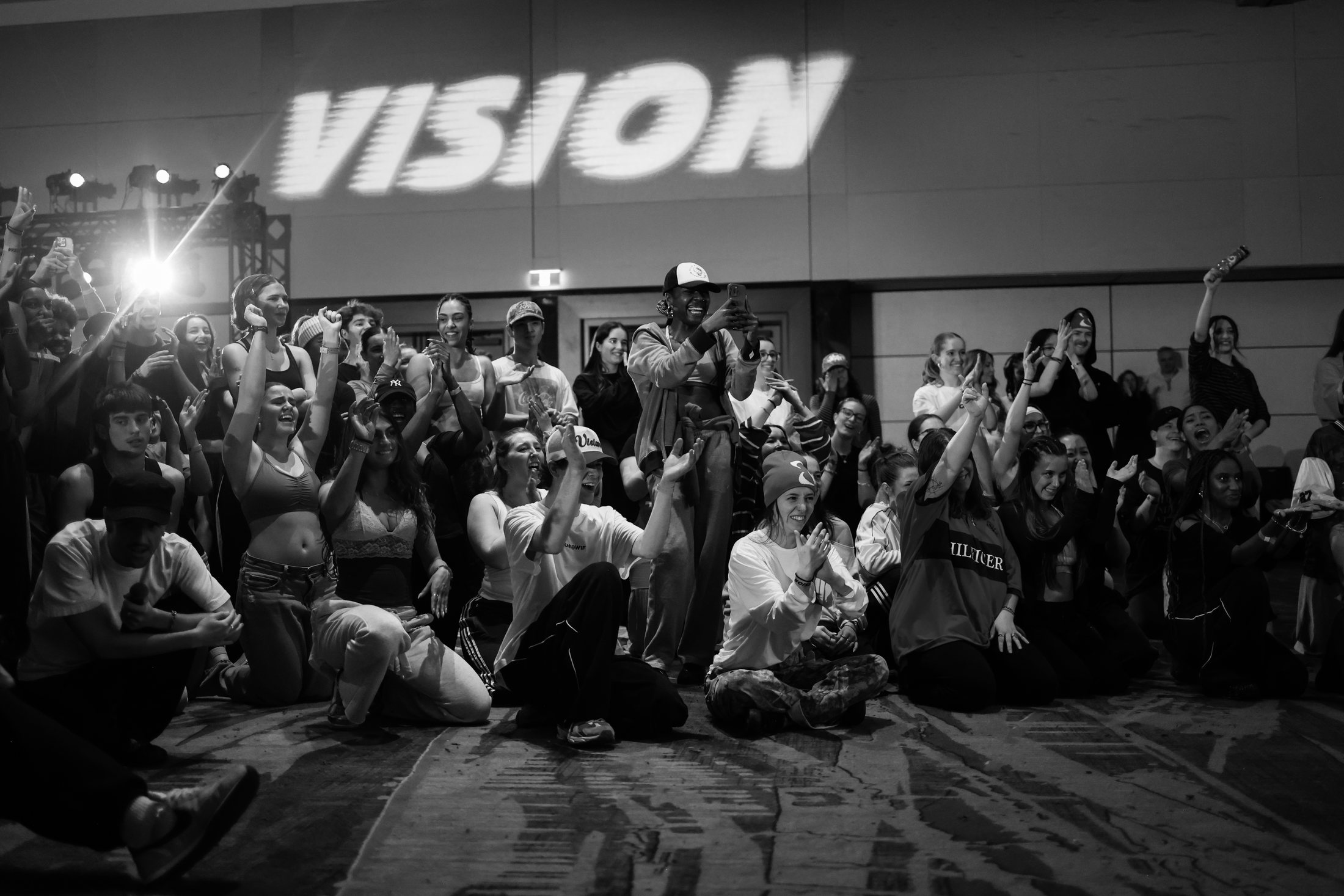 A tightly packed VISION crowd with logo visible above the room.